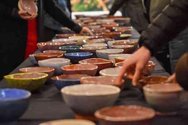 table filled with handmade pottery